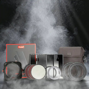 displays a set of Kase photography optical accessories (including filters and lens attachments) presented in a smoky, atmospheric scene, showcasing the product range.