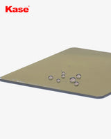 Kase brand filter with water droplets on a beige surface