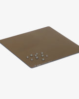 Brown square mat with small metallic objects on a white background