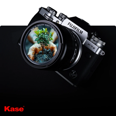 Fujifilm camera with Kase lens on a black background