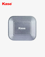 Kase brand square metal object on a white background