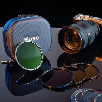 A set of Kase photography gear (lens, filters, case) laid out neatly, presenting the brand’s optical accessory collection.