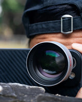 Camera lens with a blurred natural background